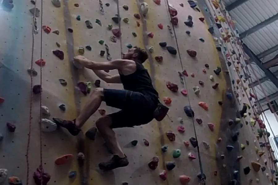 Tom climbing an indoor climbing wall